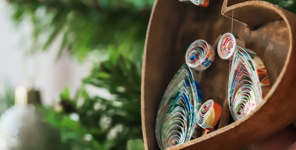 Heart-shaped carved cinnamon with recycled paper nativity figurines