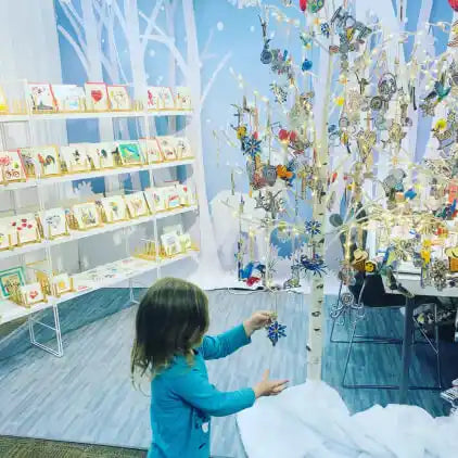 little girl customer playing with ornament