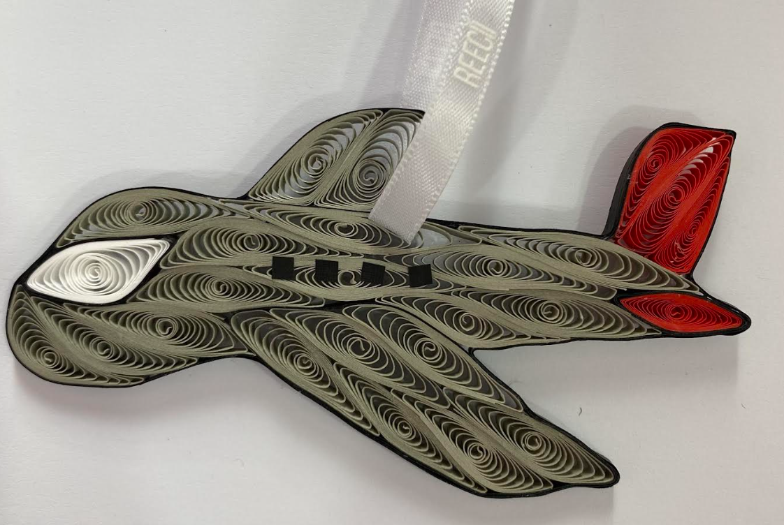 A paper quilling grey airplane ornament