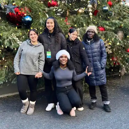 Staff photo in front of Christmas tree 